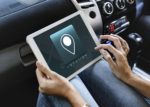 Person Using White Tablet Computer Displaying Cell Phone Location