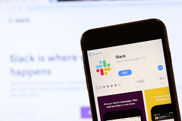 Phone with Slack icon on screen.