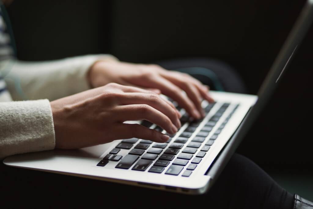 writing on laptop