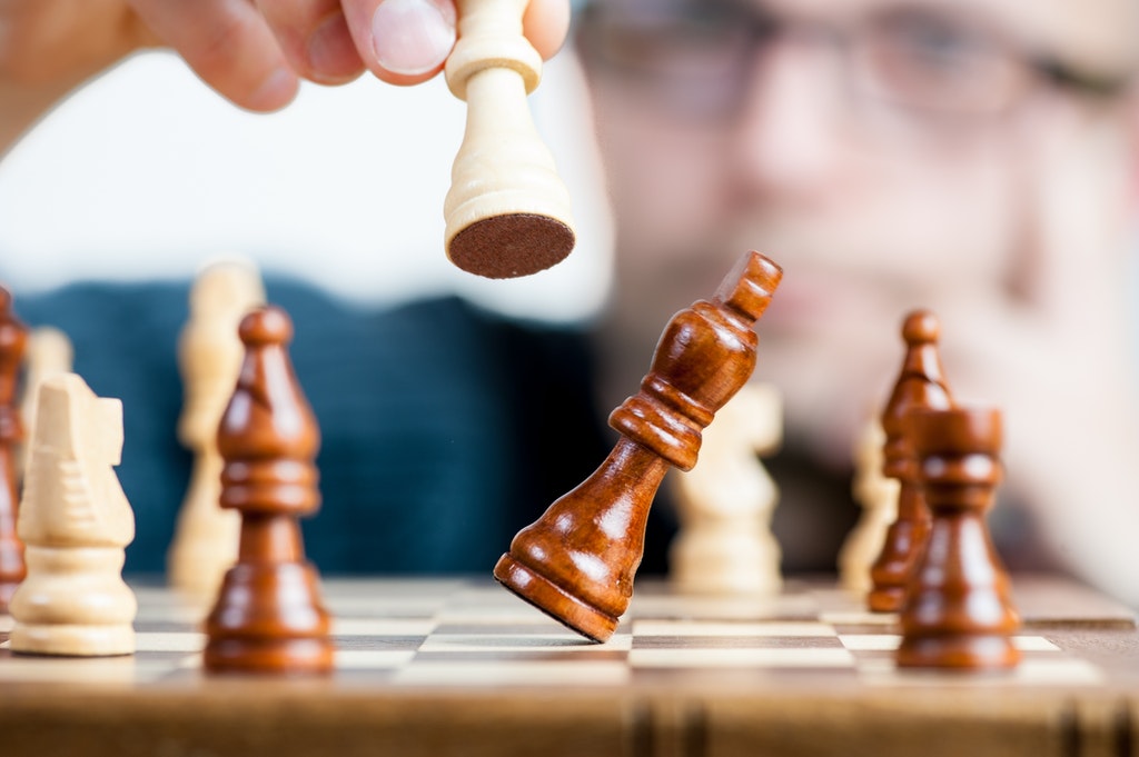 Man holding Chess piece.