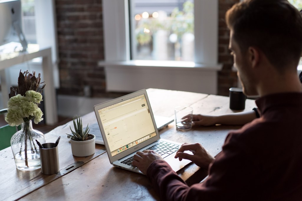 Man at a laptop in an office.
