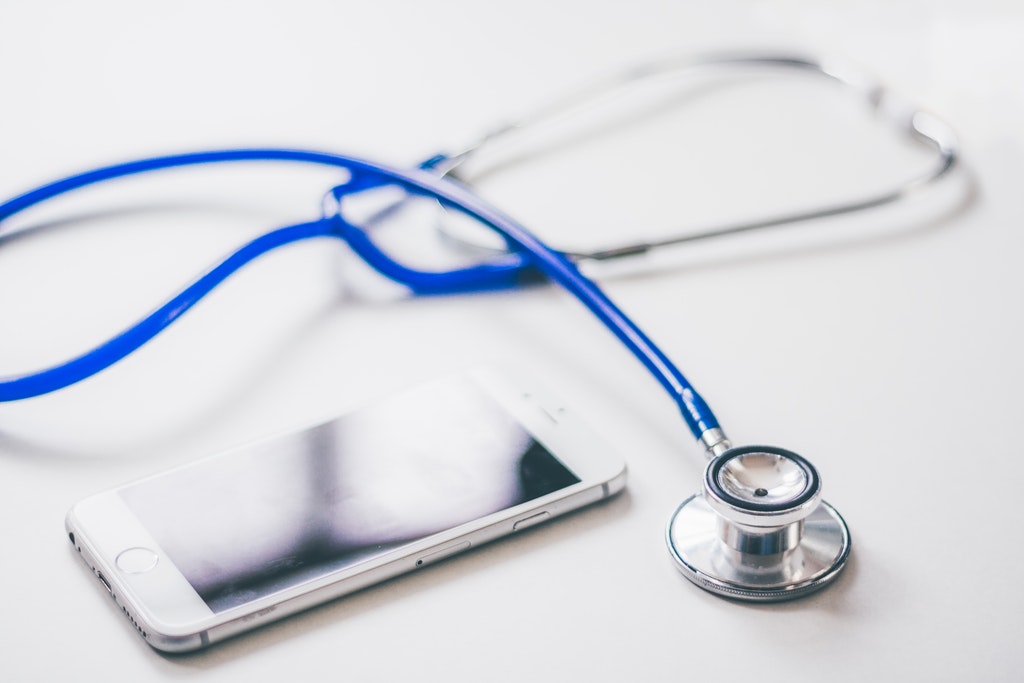 This photo is about iPhone, Stethoscope, Online Doctor Apps.