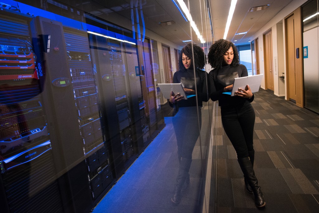 Standing Woman Holding Laptop, Data Center, SQL Server, Database Engineer, DBA