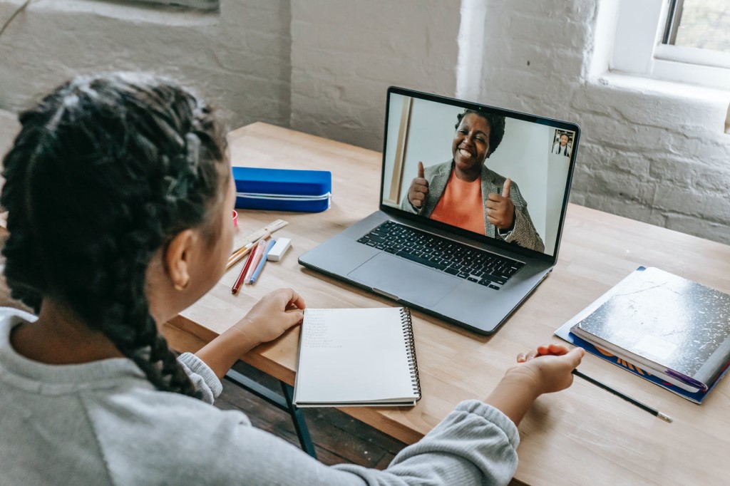 Girl having video chat with teacher online
