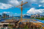 Tower Crane and Building Modern Under Construction Against Blue Sky at South Korea