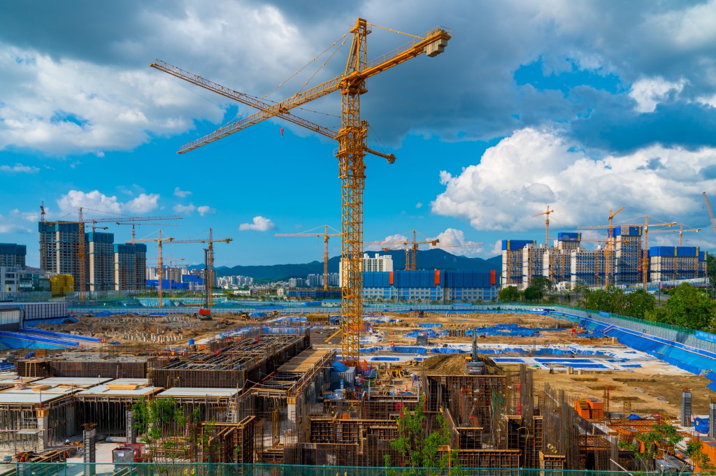Tower Crane and Building Modern Under Construction Against Blue Sky at South Korea.