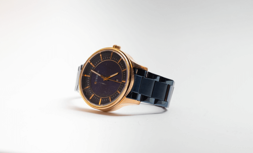 Gold and black round Curren Analog Watch photo