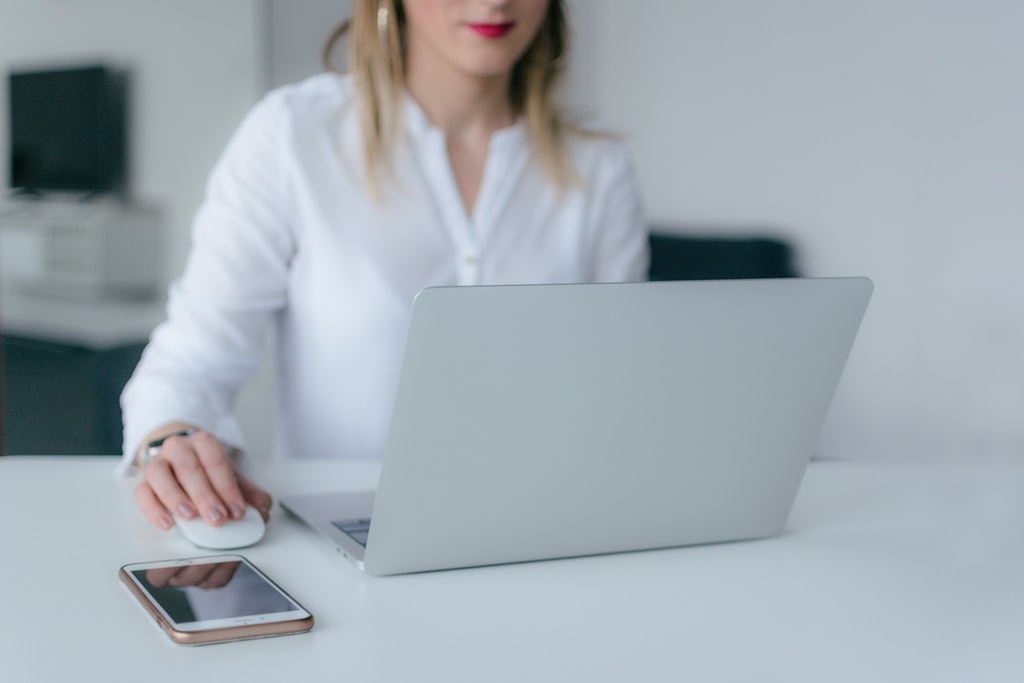 Woman Using MacBook Air and Apple Magic Mouse photo