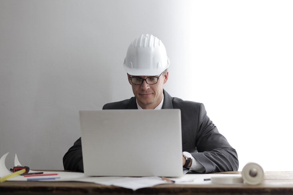 Serious engineer working on laptop