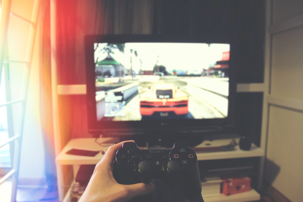 Person Holding Sony PlayStation Ps3 Controller Playing Grand Theft Auto