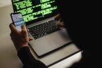 Developer using laptop and smartphone, Mobile app development.