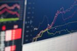 Close Up Photo of Monitor Displaying Stock Charts Graph During a Live Trading Session