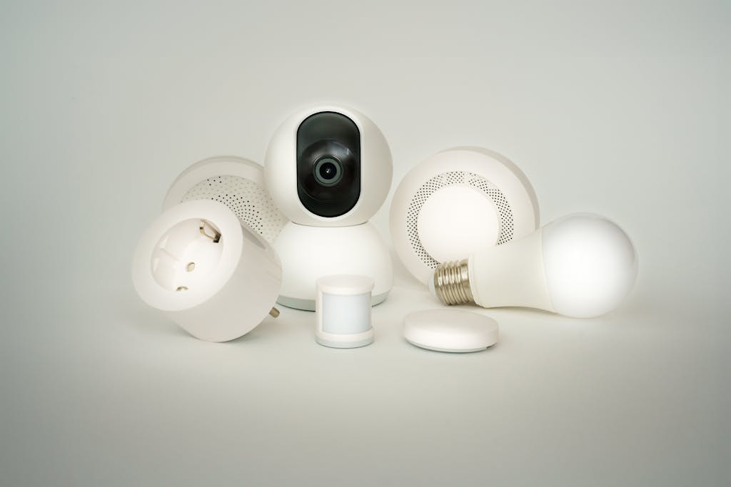 Smart home devices collection, smart bulbs, sockets, security alarms and cameras on white background.